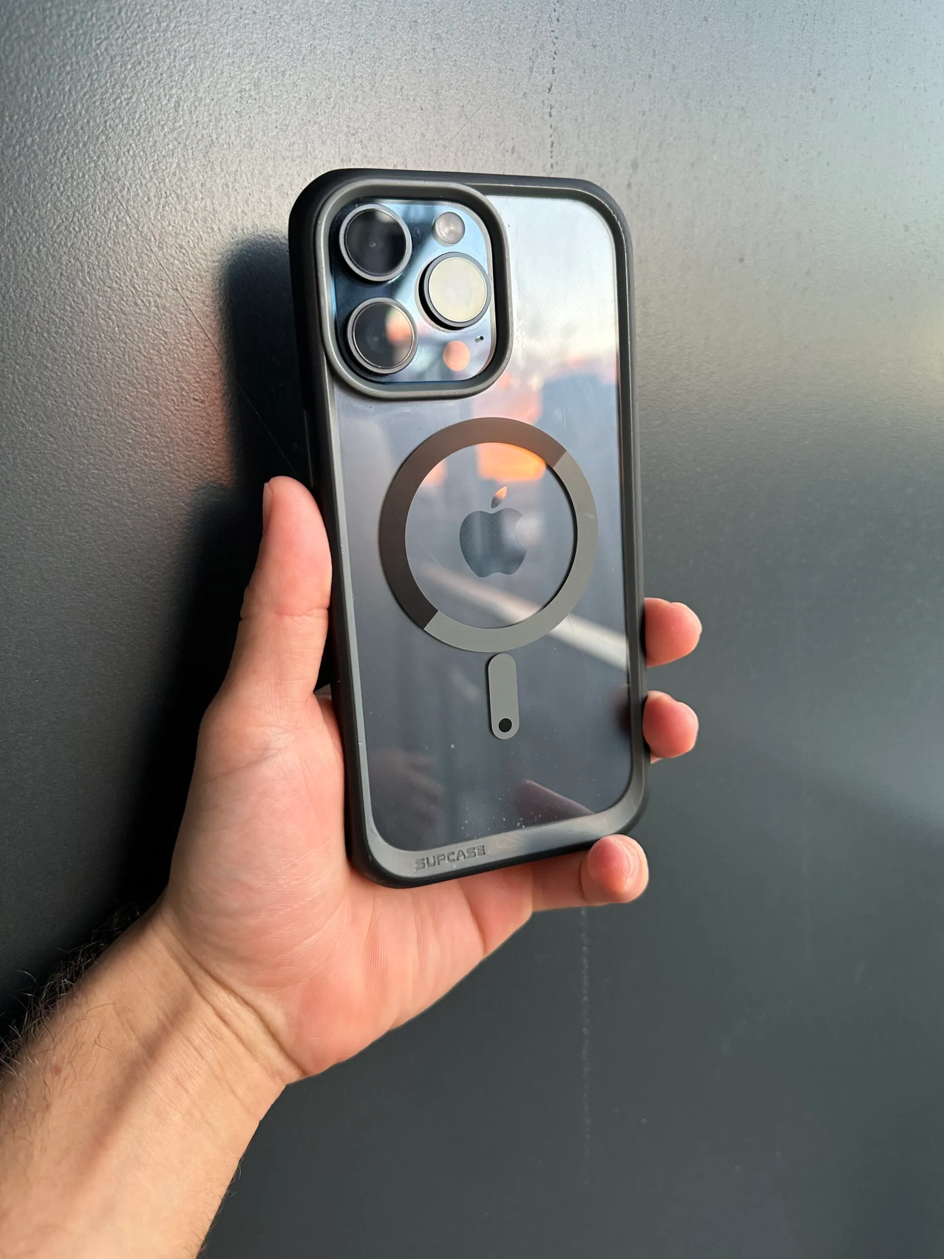 iPhone with sunset reflection in the screen